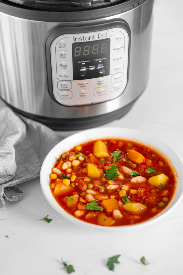 Photo of a bowl of Instant Pot vegetable soup with an Instant Pot