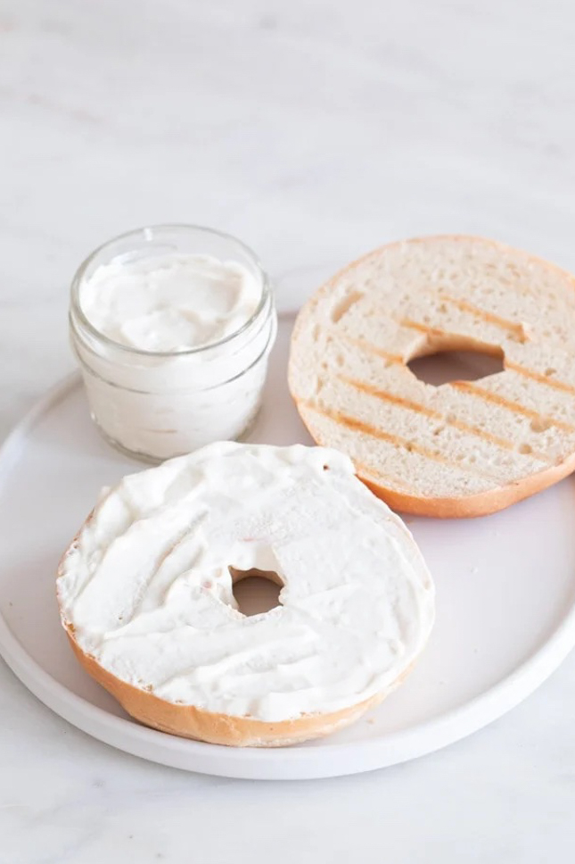 Photo of some vegan cream cheese spread over a bagel