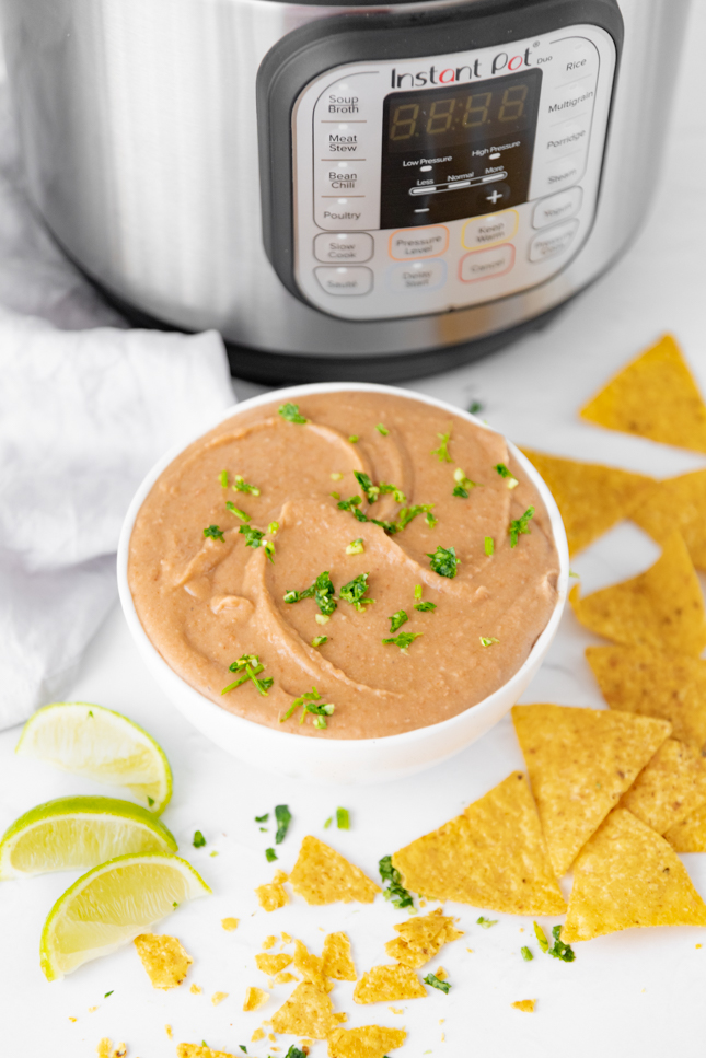 Photo of a bowl of Instant Pot refried beans with an Instant Pot