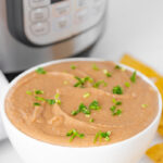 Photo of a bowl of Intant Pot refried beans with the words Instant Pot refried beans