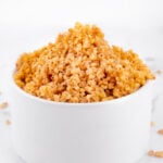 Side photo of a bowl of cooked millet with a heading