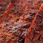 Close-up photo of some slices of vegan bacon with a heading