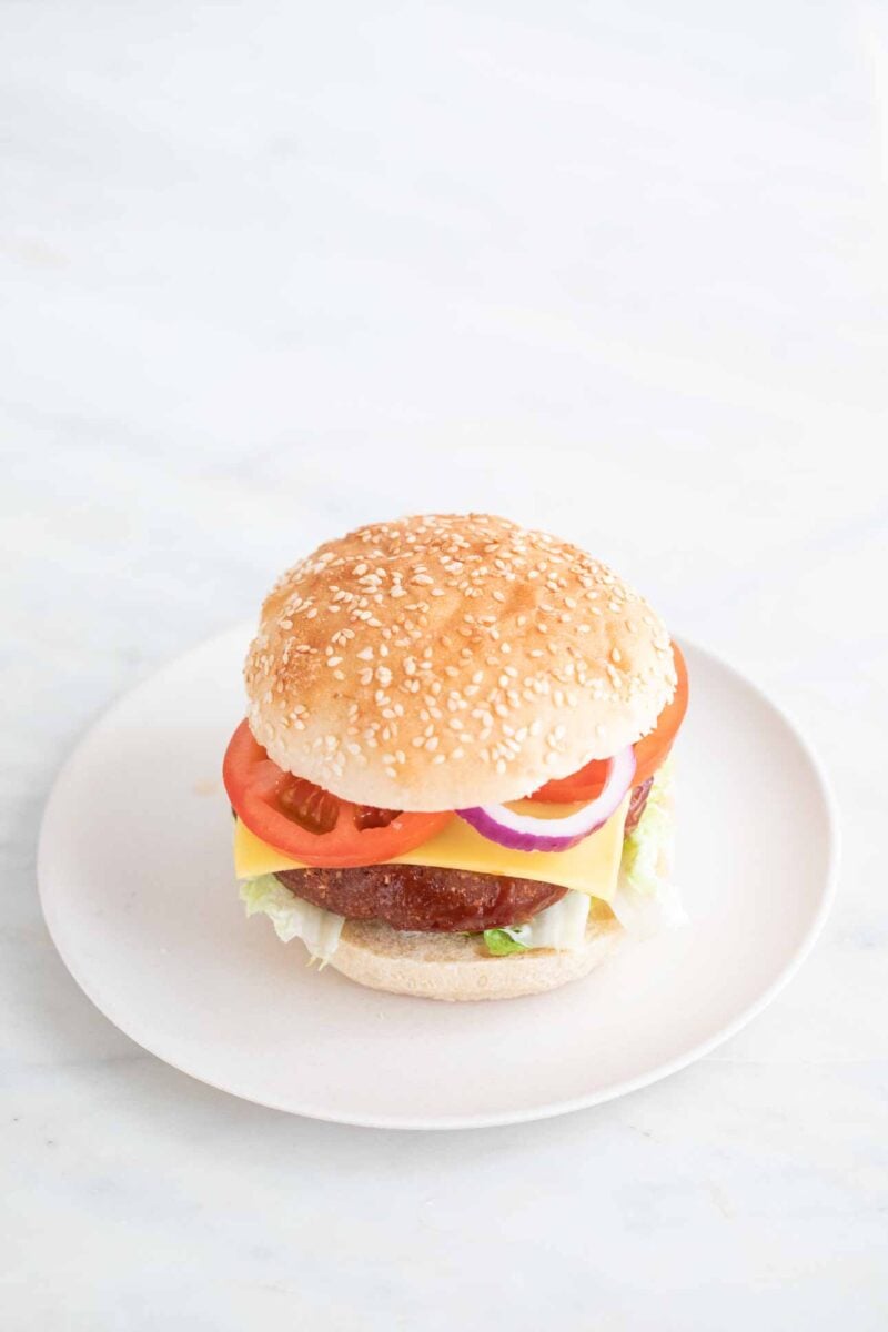 A picture of a vegan burger onto a white dish