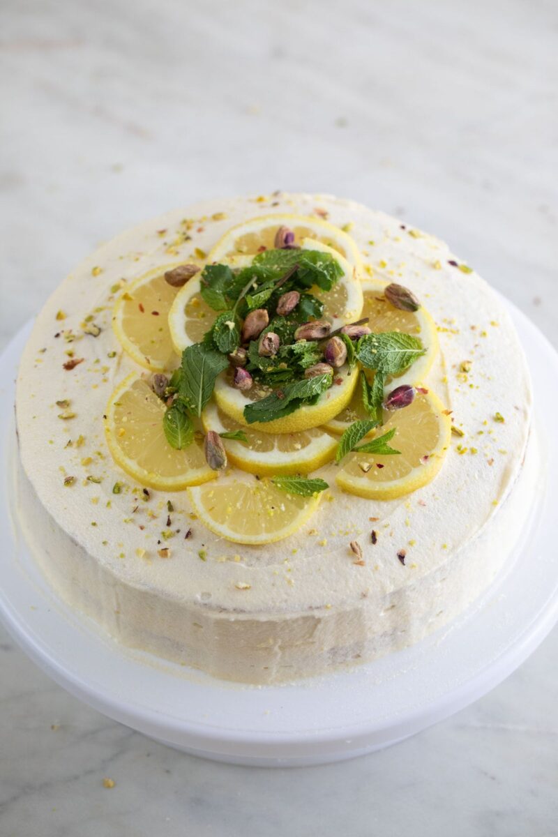 A picture of a vegan lemon cake on a cake stand