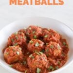 A photo of a shallow dish of vegan meatballs with some chopped parsley on top