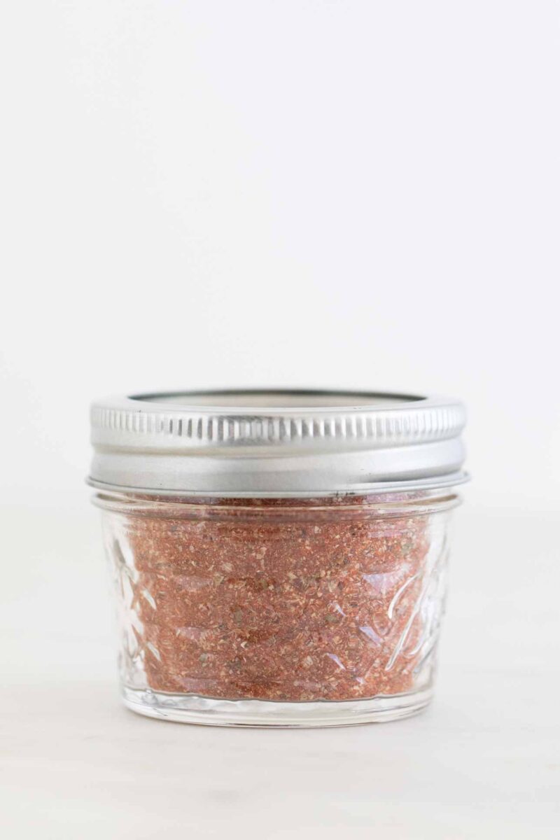 Side photo of a closed jar with homemade Cajun seasoning