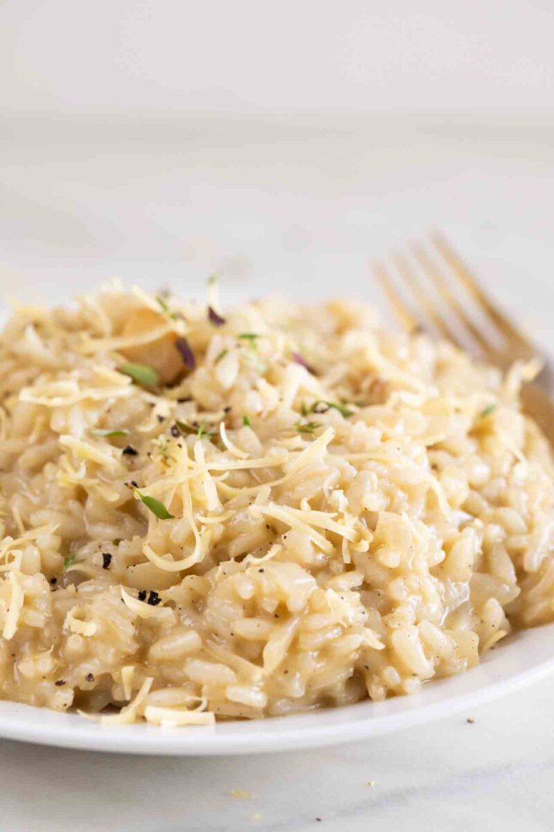 Close-up photo of a dish of vegan risotto with a fork