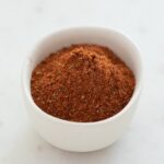 Sqaure photo of a small bowl with homemade Old Bay seasoning.
