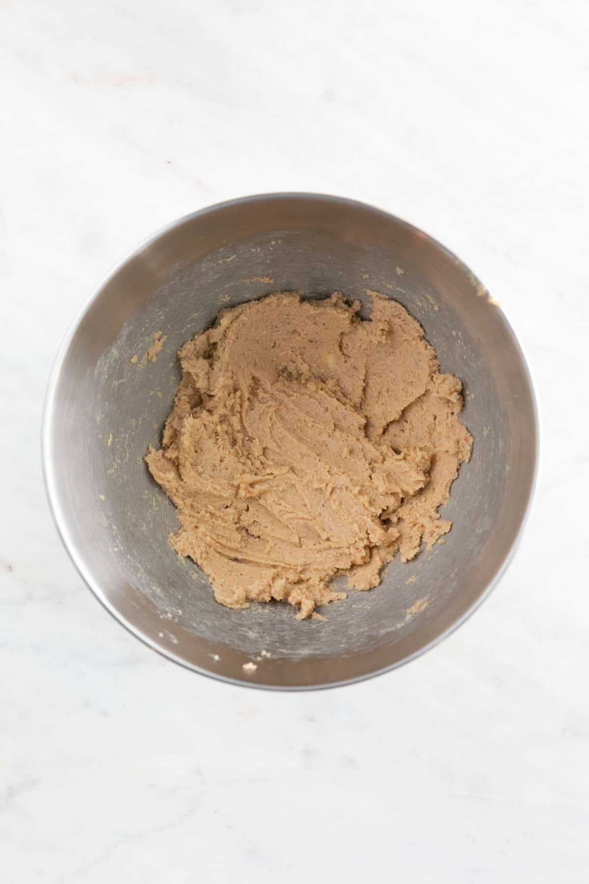 The vegan butter, granulated sugar, and brown sugar mixed in a large bowl.