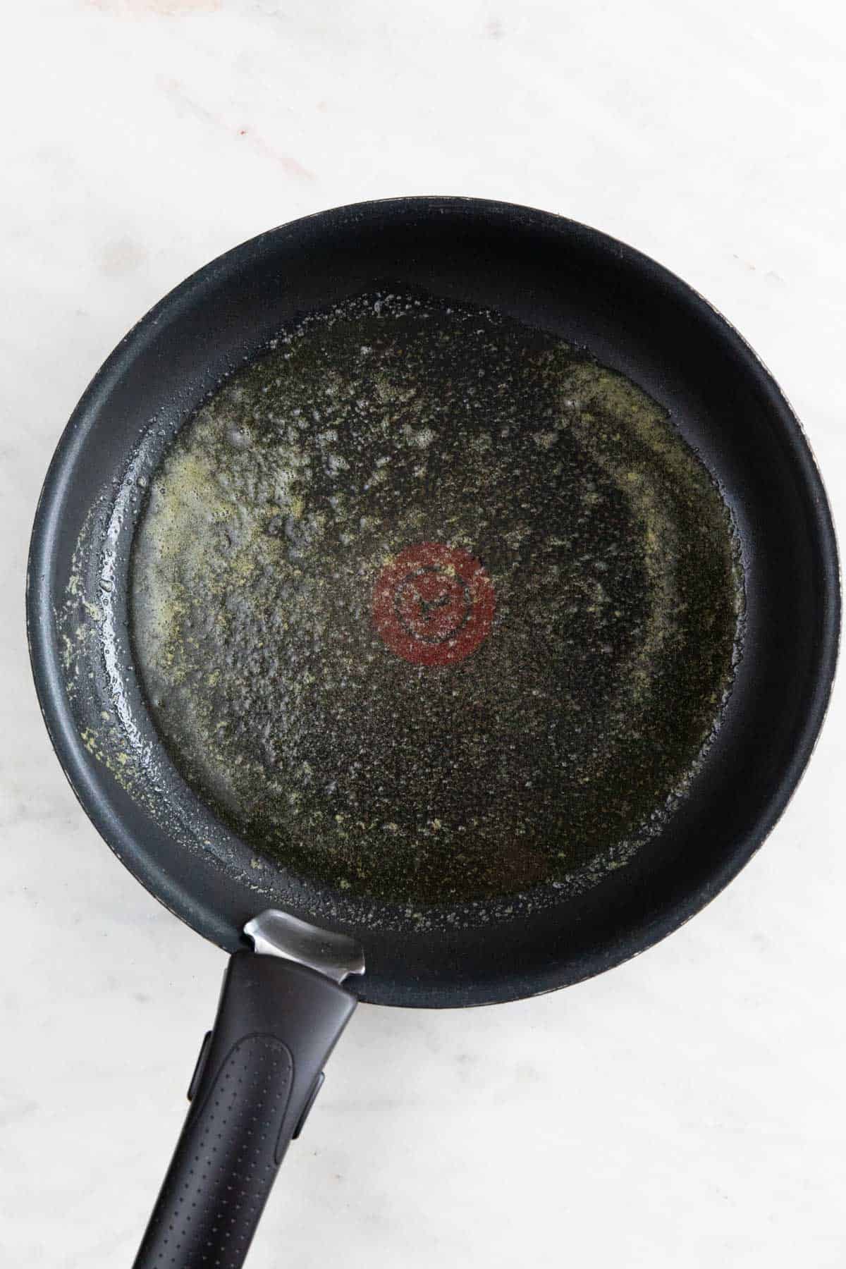 A skillet with melted vegan butter.