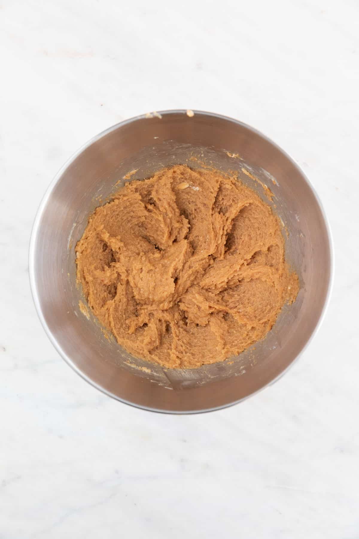 The vegan butter, peanut butter, sugar, and vanilla extract mixed in a large bowl.