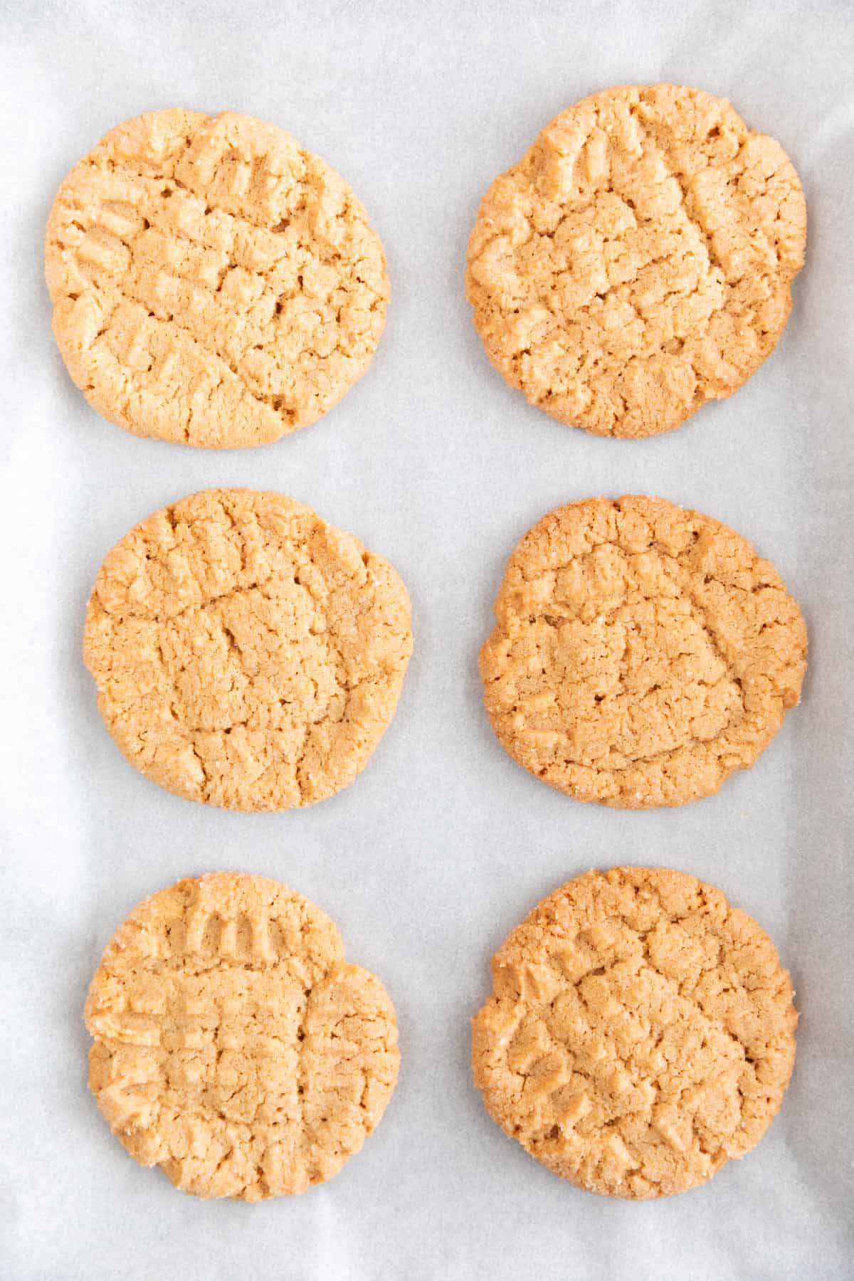 Baked vegan peanut butter cookies onto a lined baking sheet.