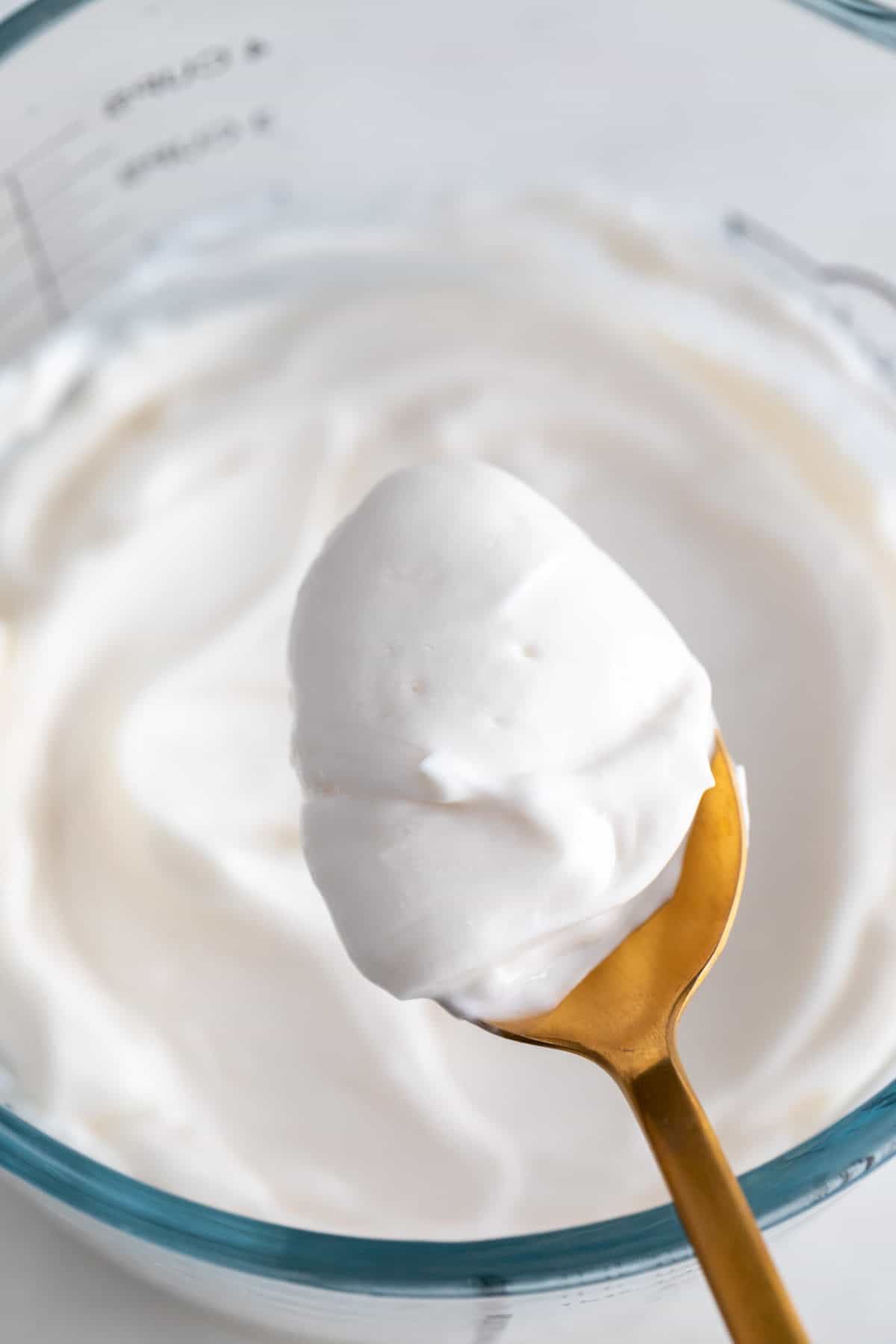 A spoon with vegan mayonnaise.