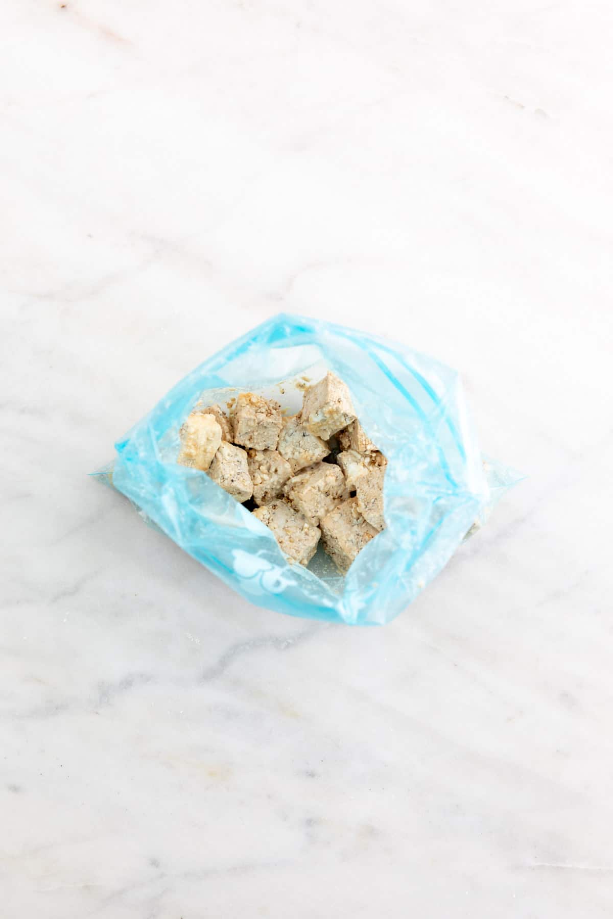 Tofu cubes in a freezer bag already mixed with the cornstarch.