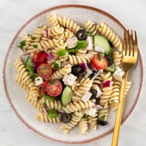 Vegan pasta salad on a plate with a fork.
