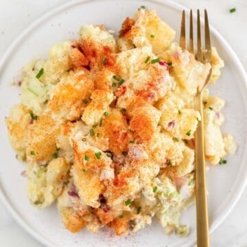 Vegan potato salad on a plate with a fork.