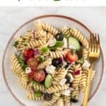 Vegan pasta salad on a dish, fork included.