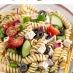 Vegan pasta salad in a shallow dish, with a fork.
