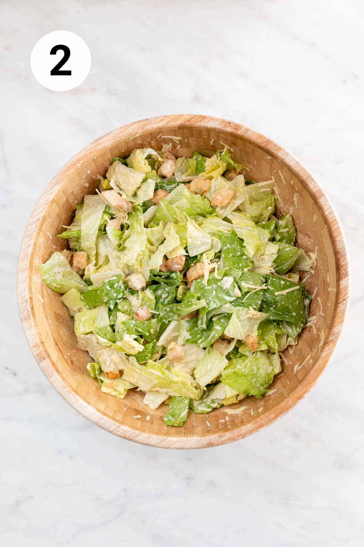Mixed vegan Caesar salad ingredients in a bowl.