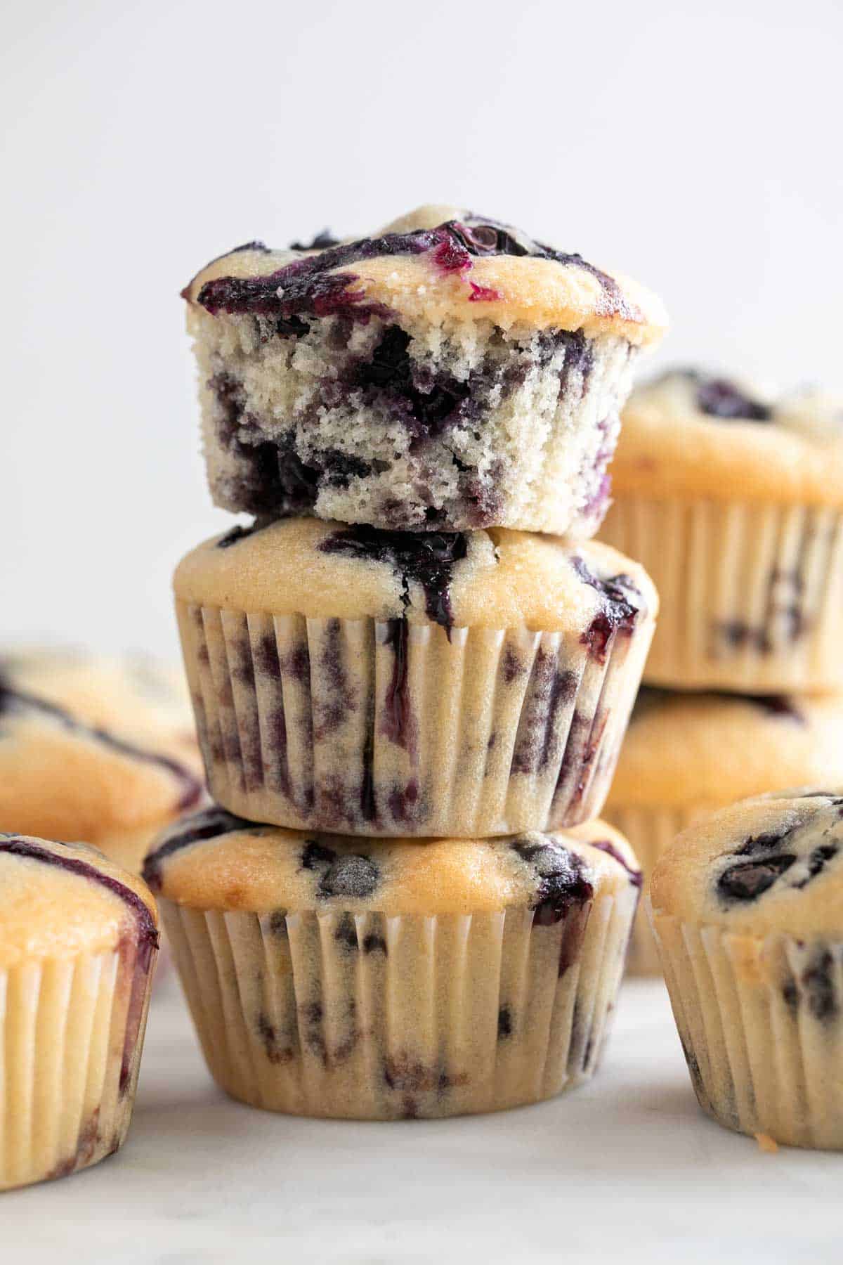 Stacked arrangement of three vegan blueberry muffins.