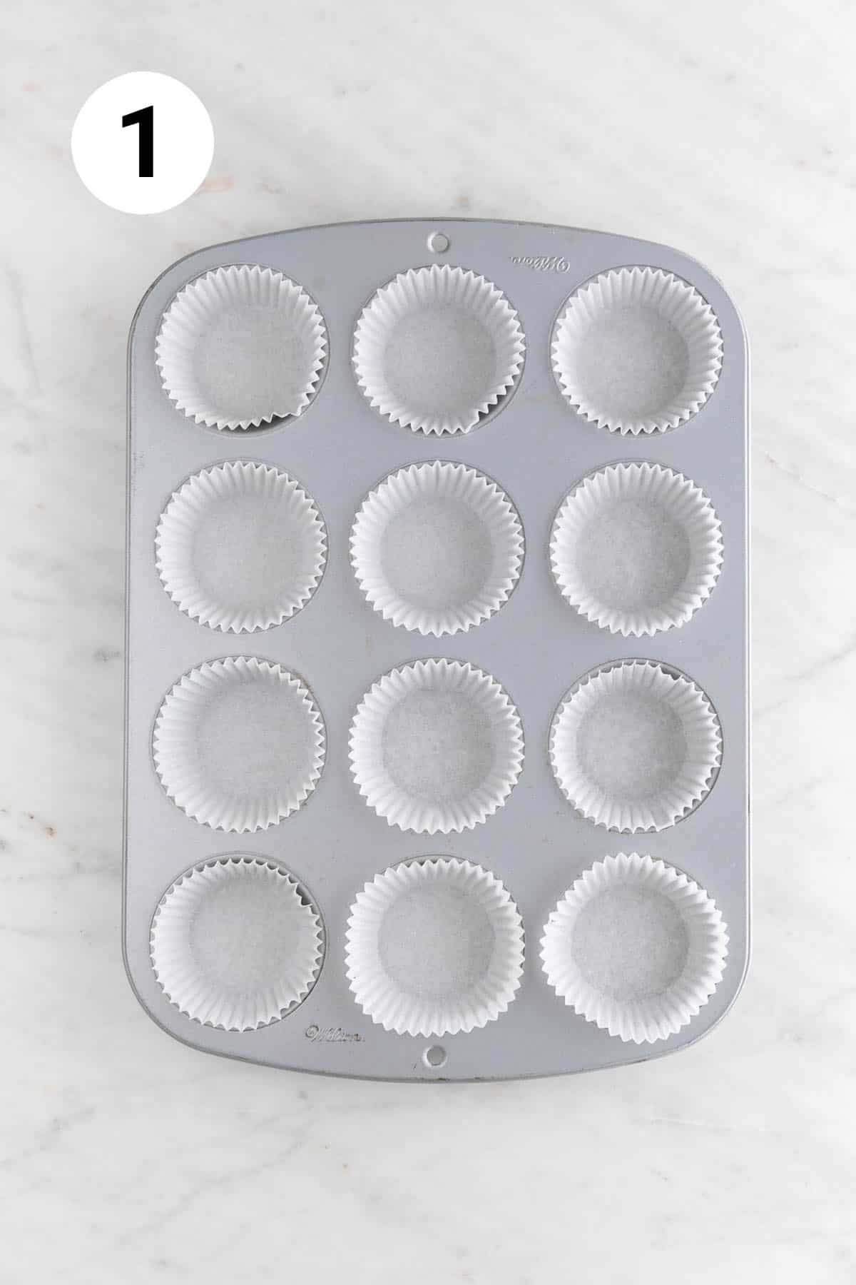Muffin tin filled with liners.