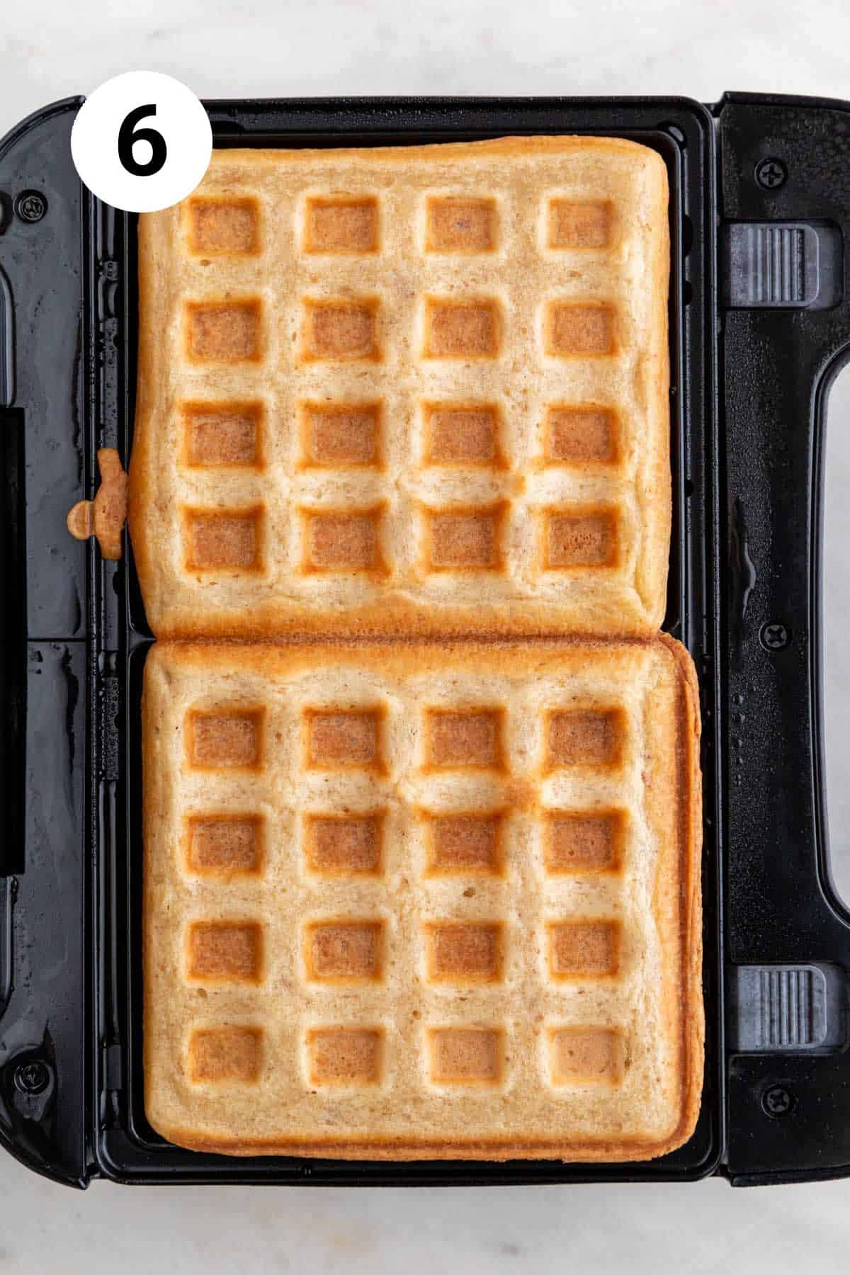 Cooked vegan waffles in a waffle maker.