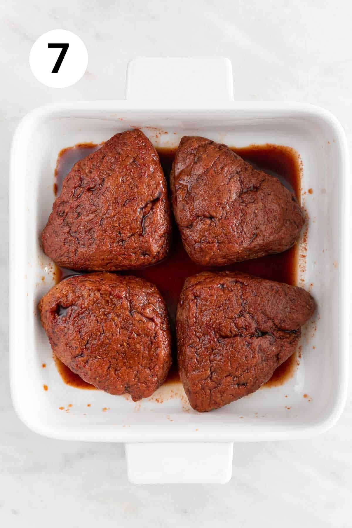 The vegan steaks soaking in the marinade.