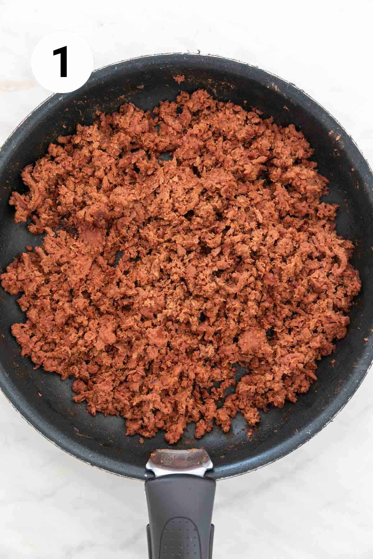 Vegan ground beef cooked in a skillet.