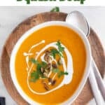 Vegan butternut squash soup in a bowl with parsley, coconut milk, and pumpkin seeds.