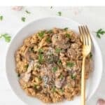 Mushroom risotto plate with a fork.