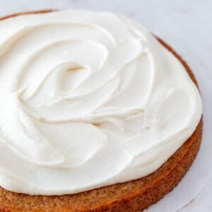 A frosted vegan vanilla cake with cream cheese frosting.