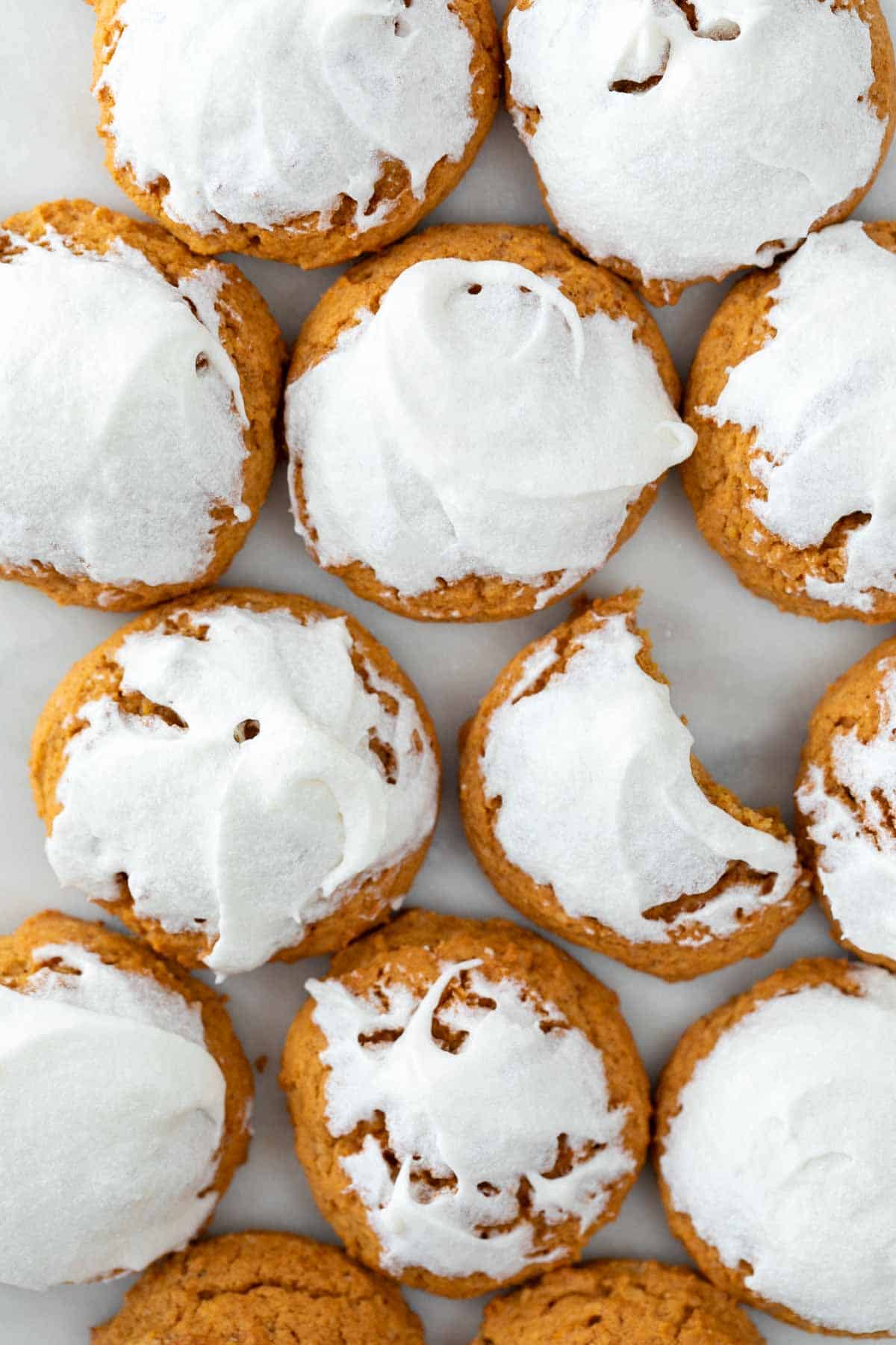 Vegan pumpkin cookies topped with vegan cream cheese frosting.
