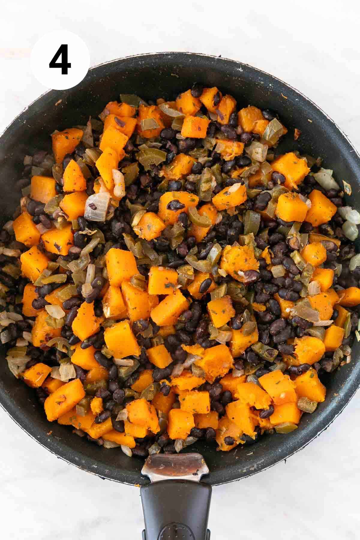 Butternut squash and black bean filling in a skillet.