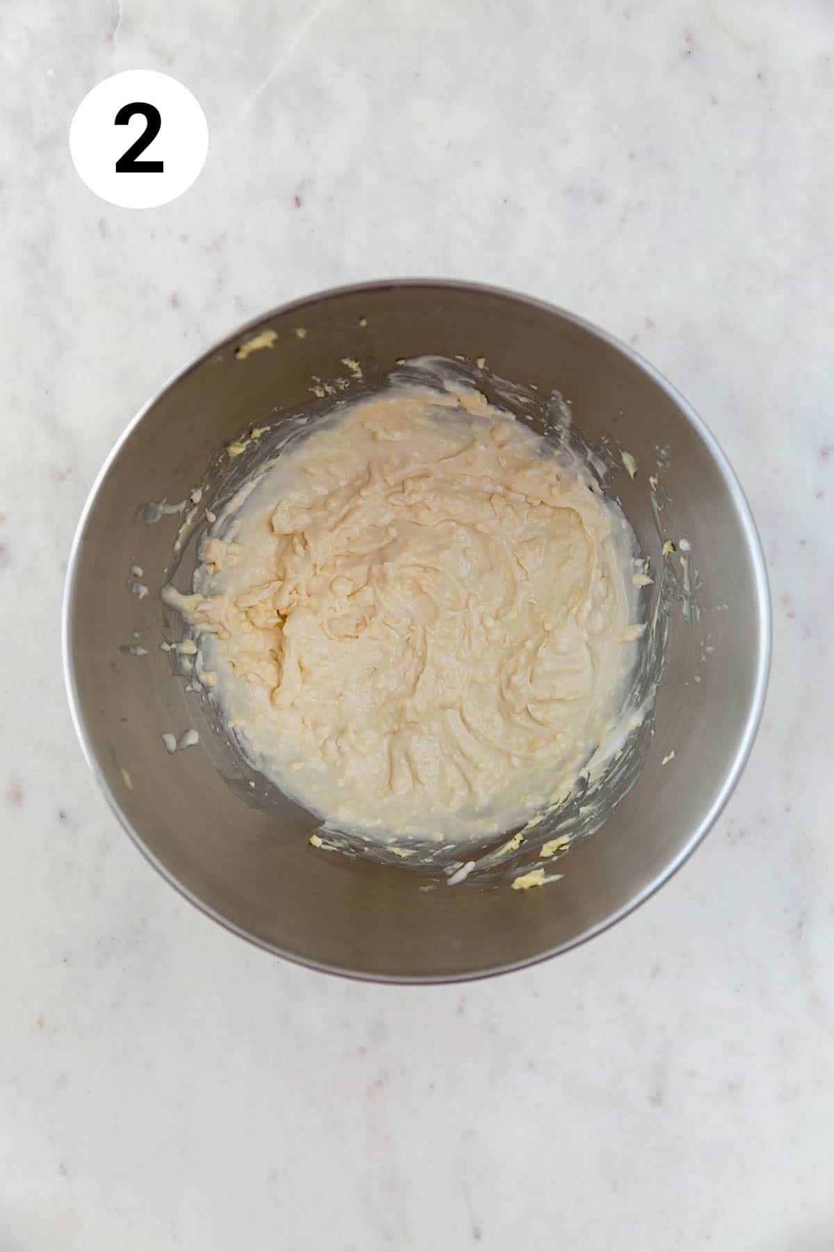 Vegan butter and vegan cream cheese beaten in the bowl of an electric mixer.