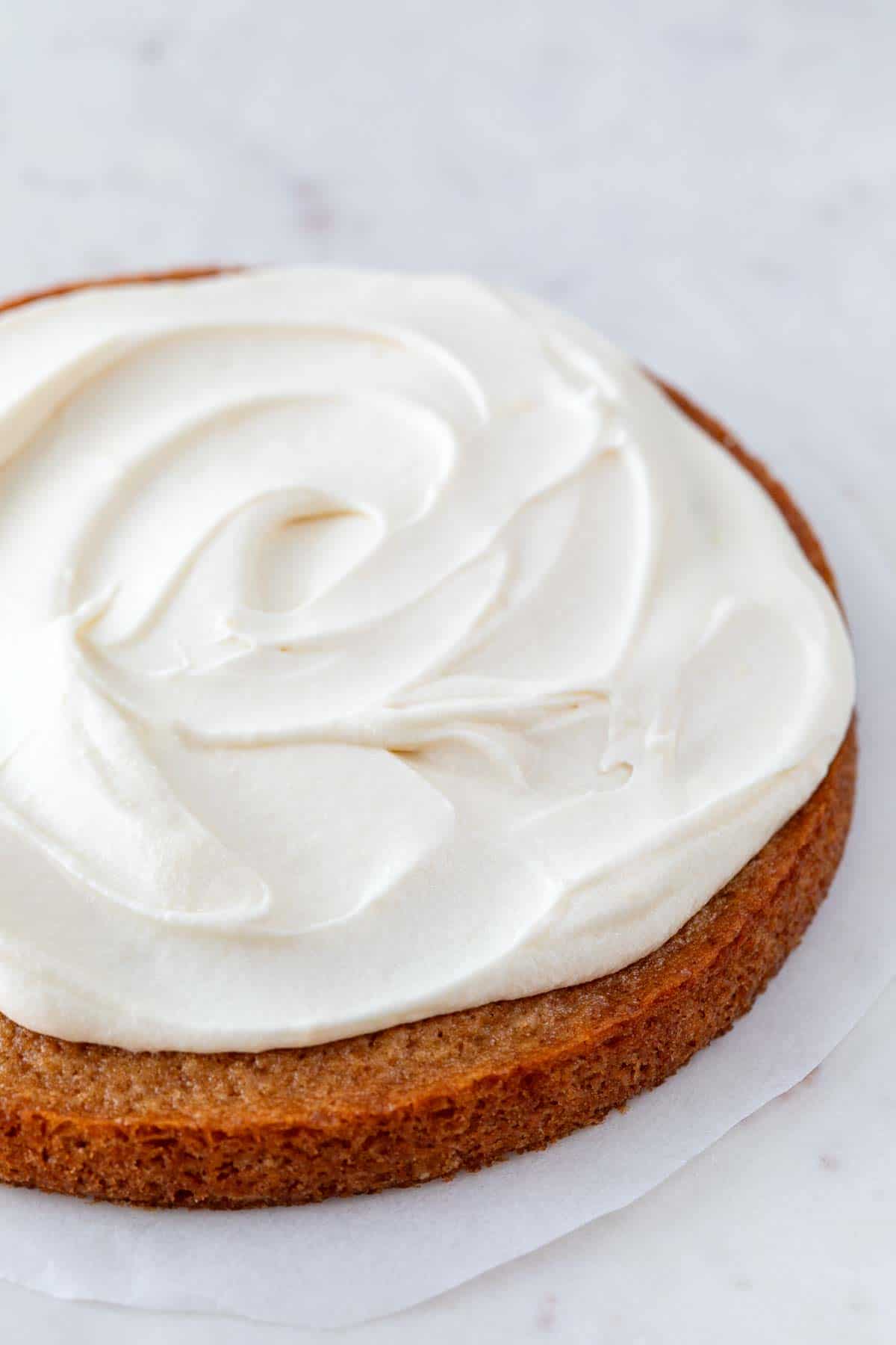 A cake with vegan cream cheese frosting on top.