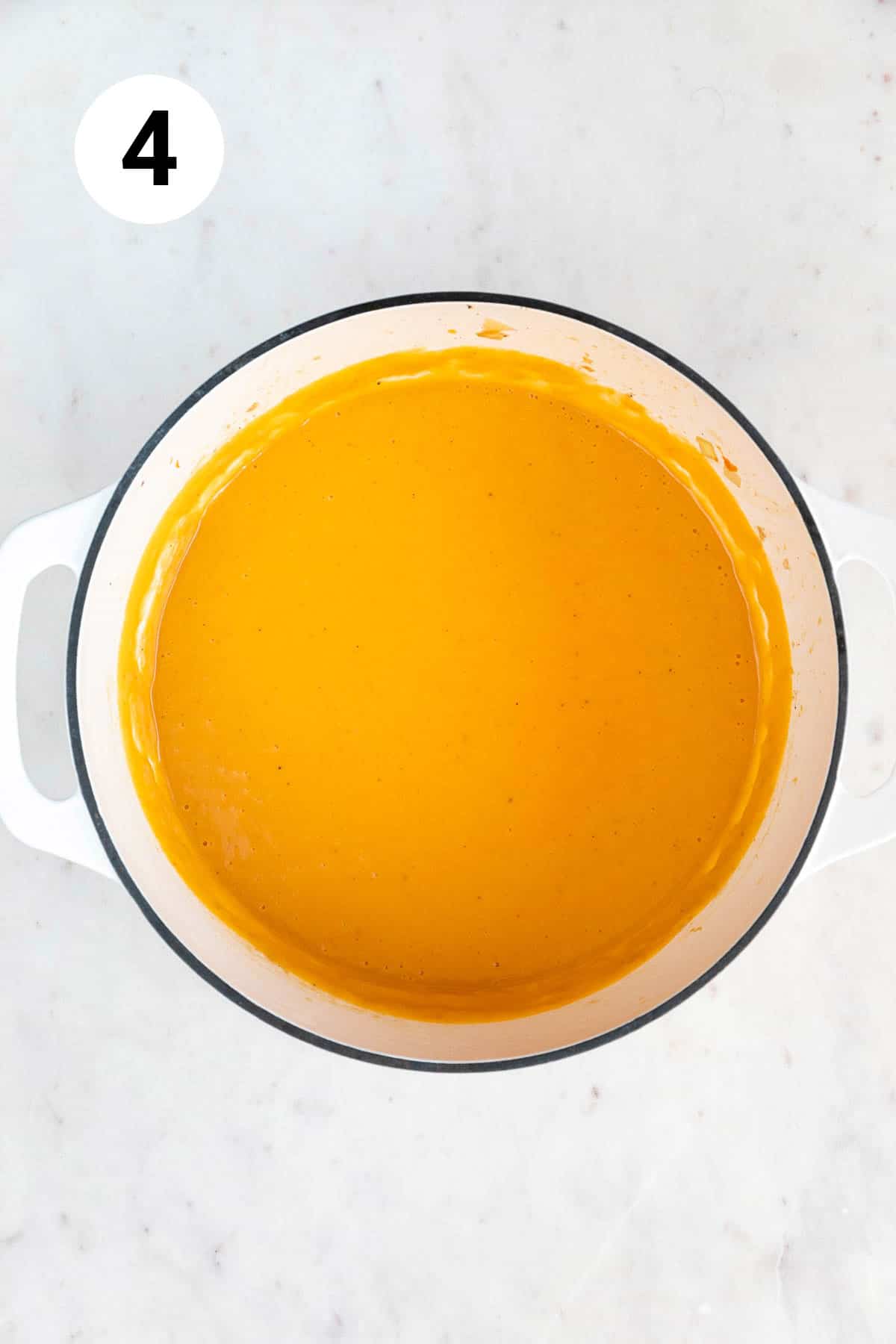 Blended vegan pumpkin soup in a large pot.