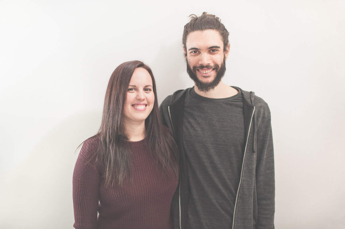 Iosune and Alberto with a white wall background.