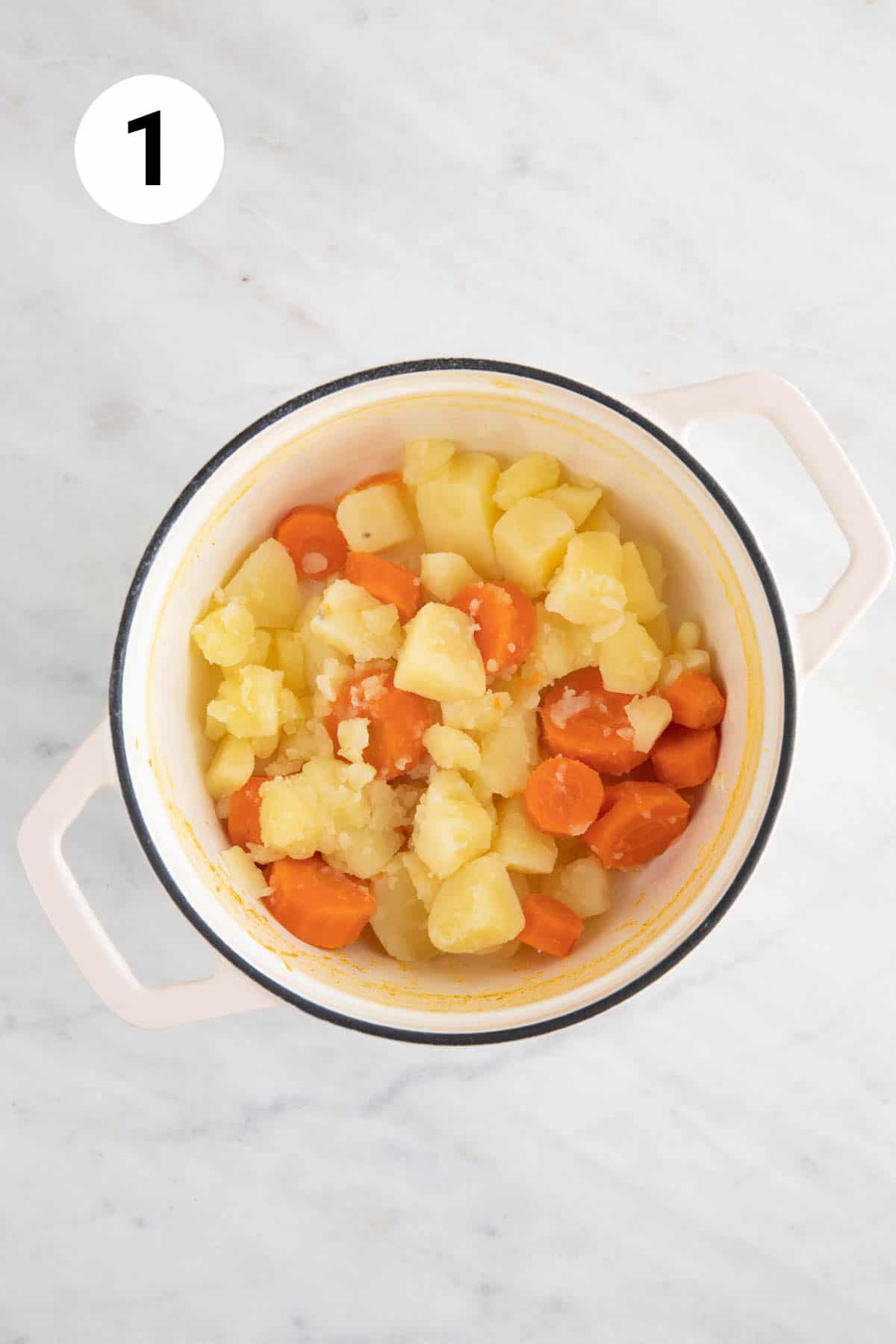 Boiled potatoes and carrots in a pot.