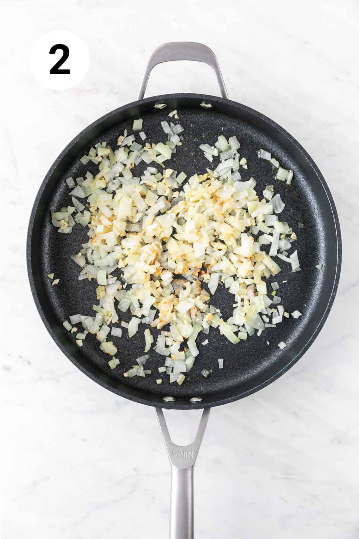 Onion and garlic sautéed in a skillet.