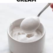 Spoonful of vegan whipped cream being lifted from a creamy bowl.