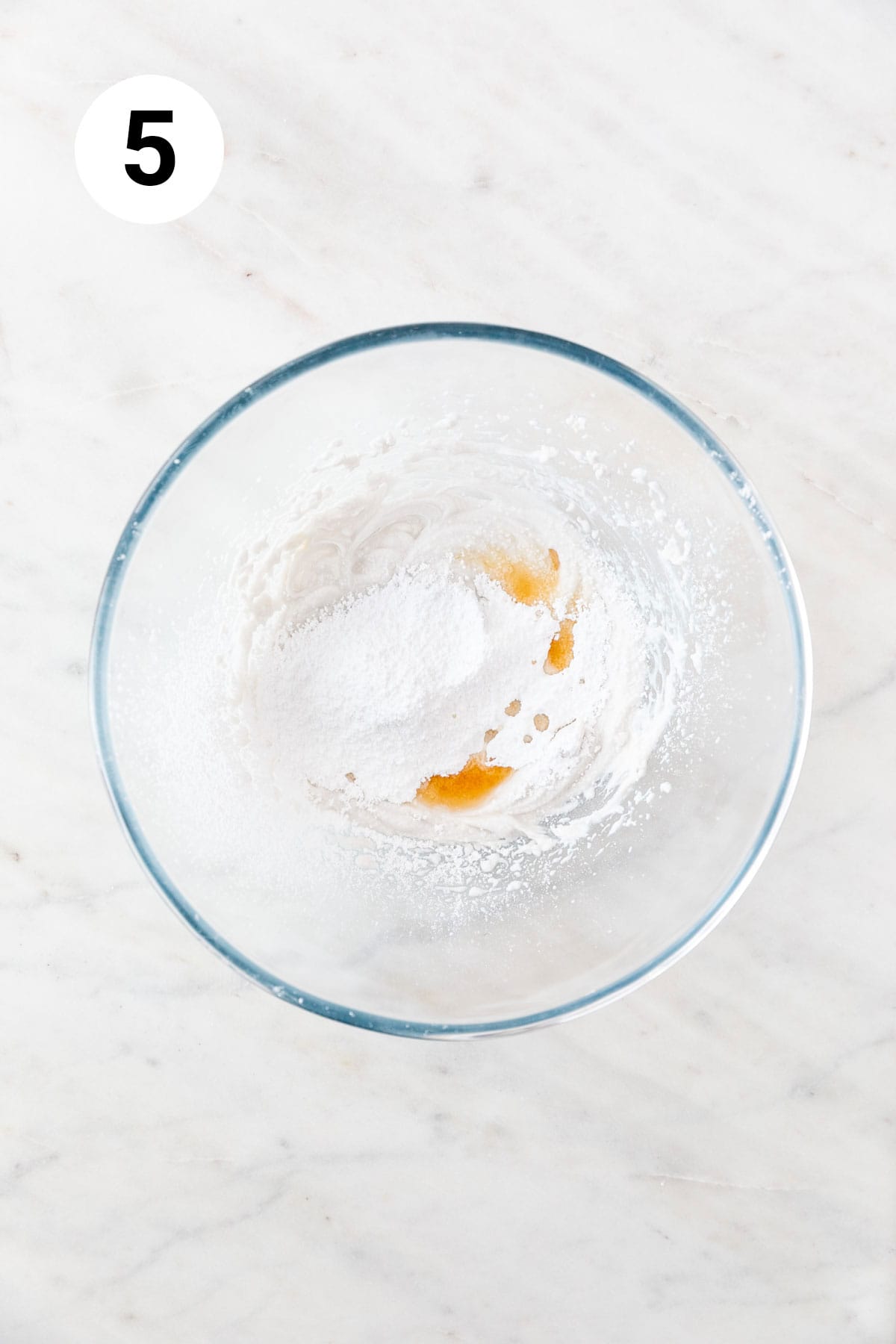 Whipped coconut cream, powdered sugar, and vanilla extract in a large mixing bowl.