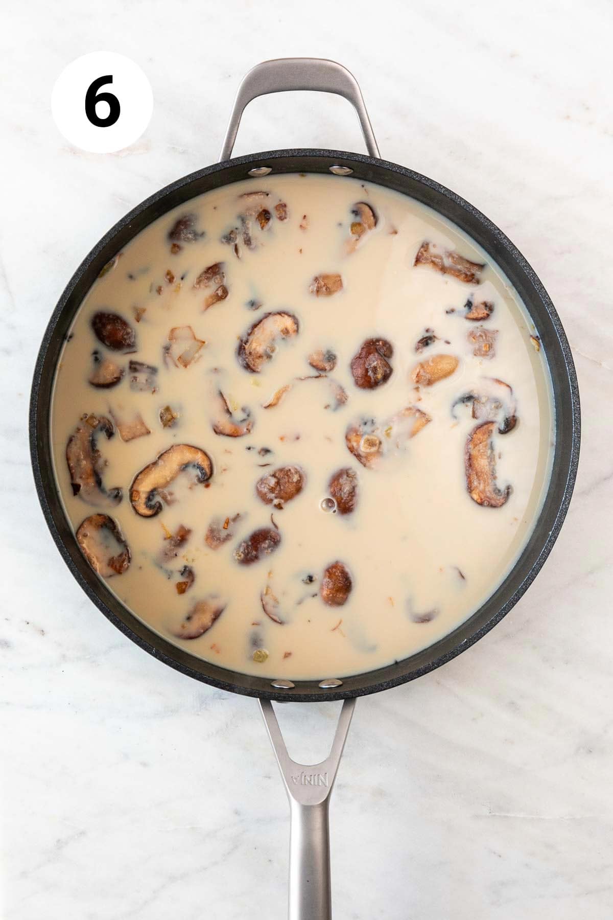 Mushroom sauce in a skillet before thickening.