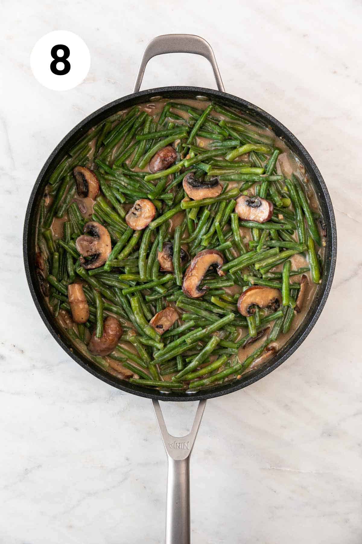 Vegan green beans and mushroom sauce in a skillet.