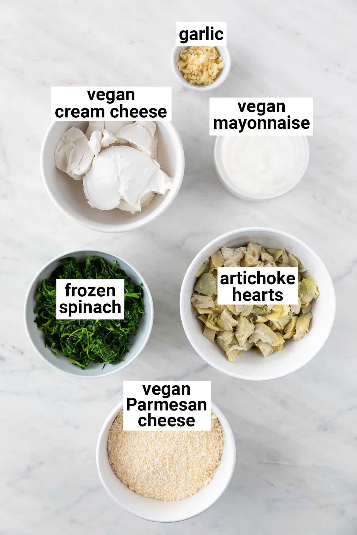Ingredients needed to make vegan spinach artichoke dip.