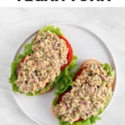 Vegan tuna sandwich with lettuce and tomato slices.