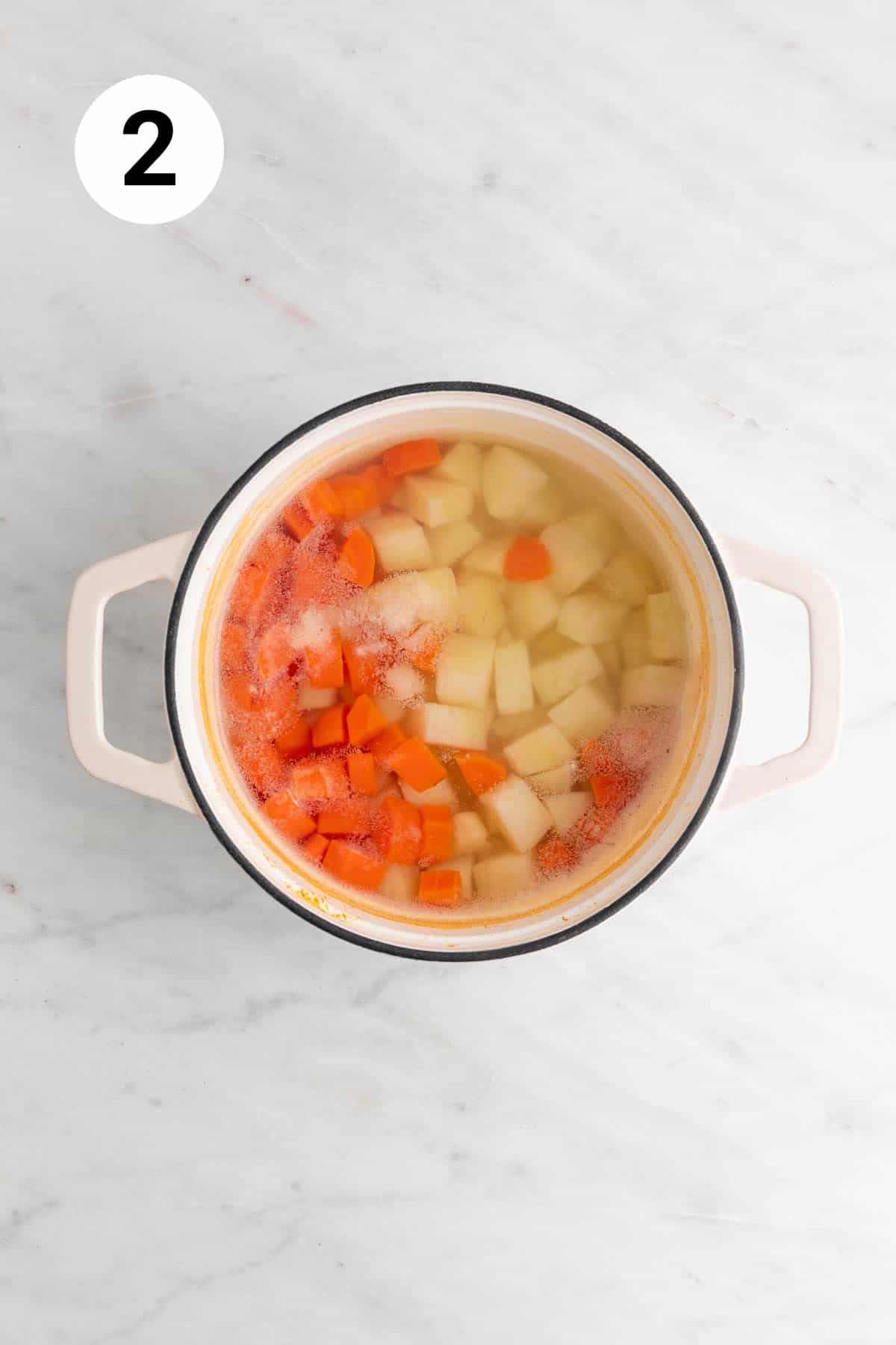 Boiled potatoes and carrots in a pot.