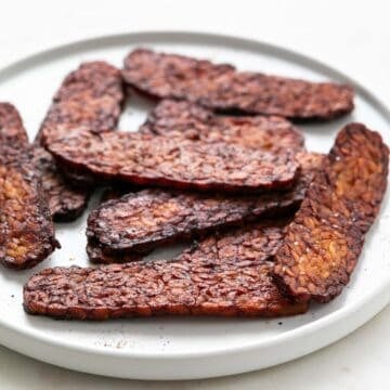 Plate with slices of smoky tempeh bacon.