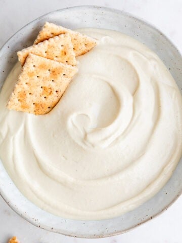 Vegan cashew cheese in bowl with crackers.