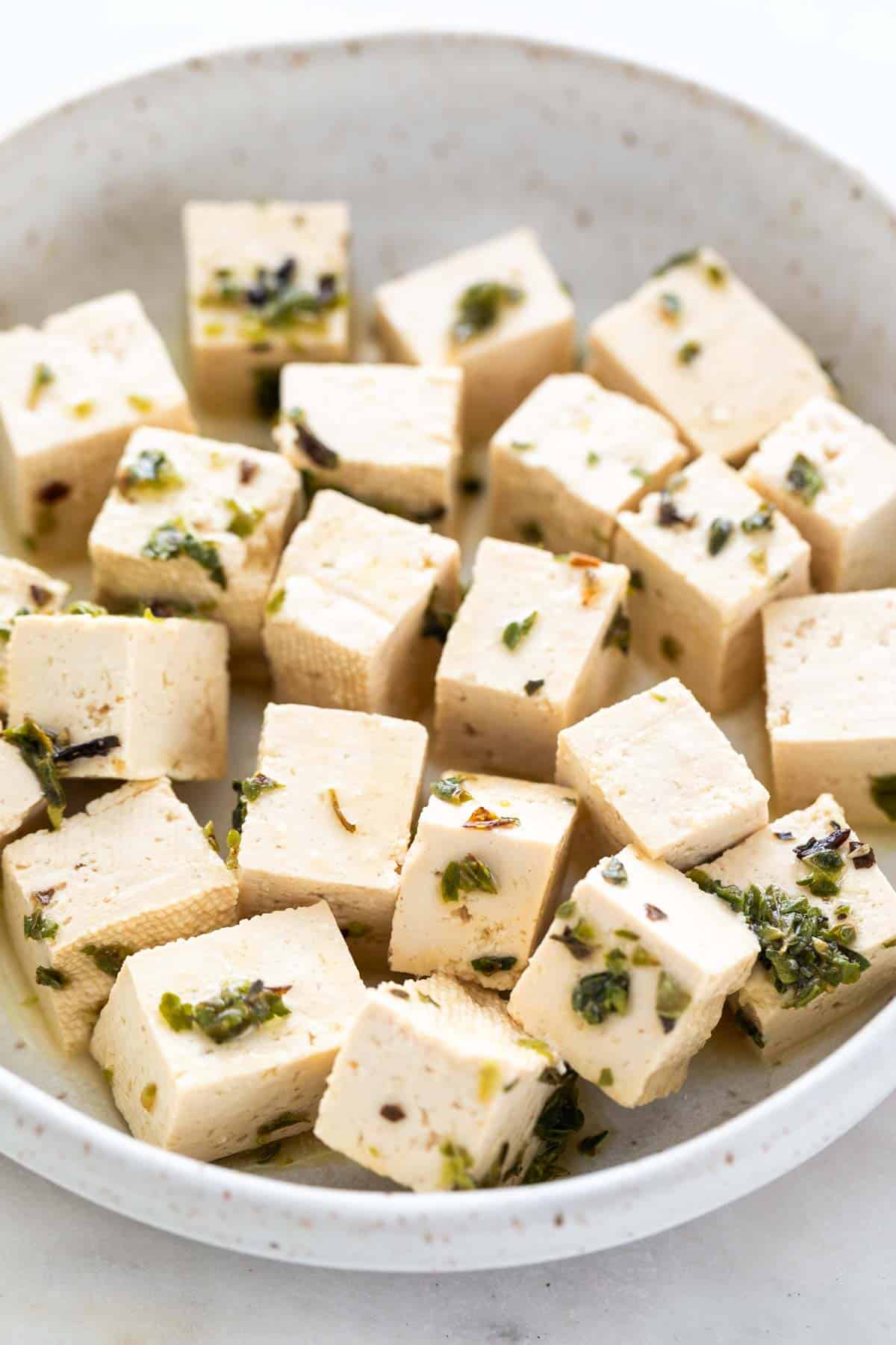 Tofu feta cheese in a dish.