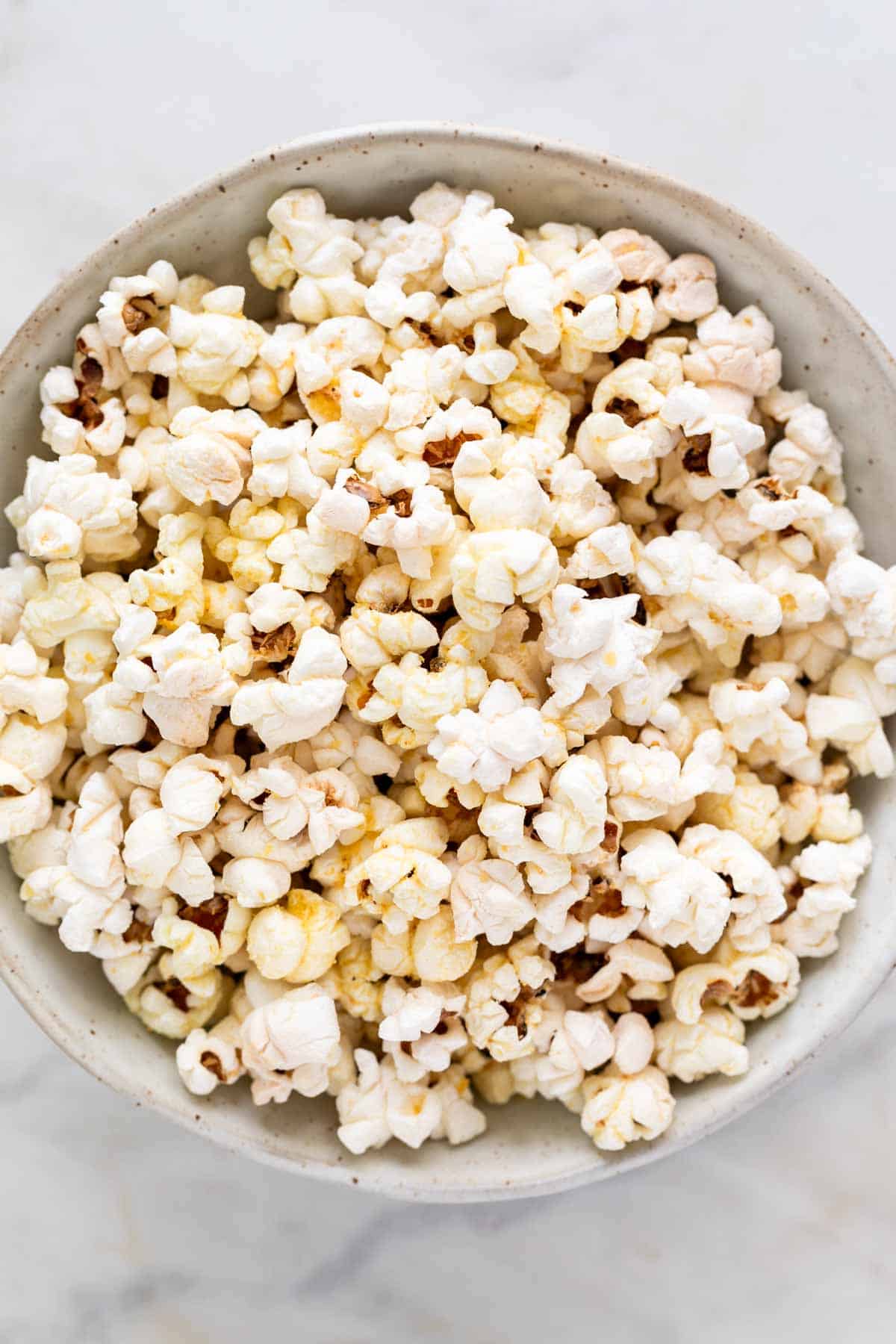 Bowl of cheesy vegan popcorn.